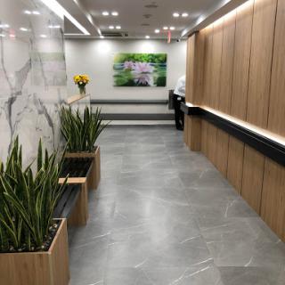 A modern lobby featuring sleek wooden paneling and decorative plants.