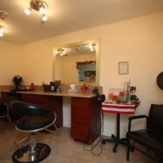 A well-equipped hair salon with chairs, mirrors, and styling tools.