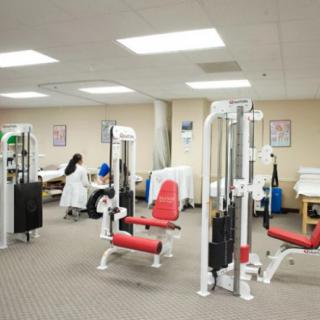 A rehabilitation center featuring various exercise machines and gym equipment.