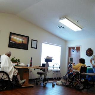 Residents engaged in activities within a bright communal area, showcasing a supportive environment.