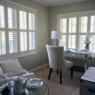 A bright and serene home office space featuring elegant furniture and soft natural light.