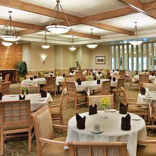 Elegant dining room interior with tables set for guests.