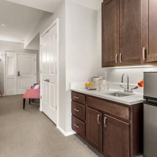 Cozy kitchen area with dark wooden cabinets and modern appliances.