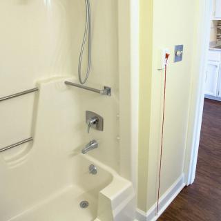 Accessible bathroom with grab bars and a shower.