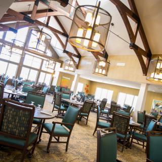 Spacious dining area with elegant lighting and ample seating.