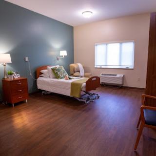A well-lit and comfortable hospital room with modern furnishings.