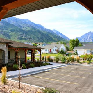 A serene view of a residential area with mountains in the background.