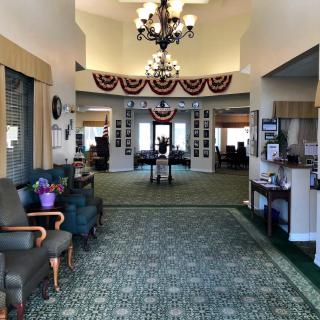 A spacious lobby with comfortable seating, elegant chandeliers, and decorative elements.