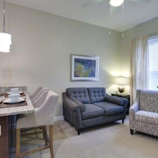 A cozy living room with a stylish sofa, armchair, and modern decor.