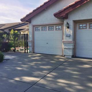 A suburban house with a double garage and driveway.