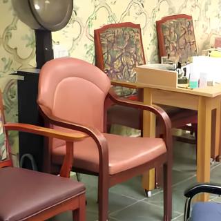 A cozy salon waiting area featuring a variety of comfortable chairs.