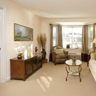 A well-lit living room with elegant furniture and decor.