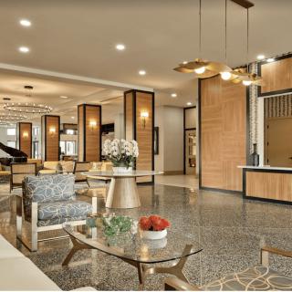 A modern hotel lobby with elegant furniture and warm lighting.