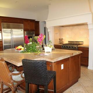 A modern kitchen with a central island and stainless steel appliances.