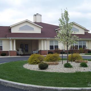 A quaint residential building with a landscaped entrance.
