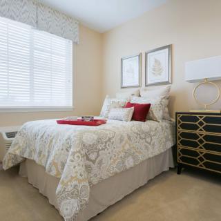 A cozy bedroom with elegant decor and a beautifully made bed.