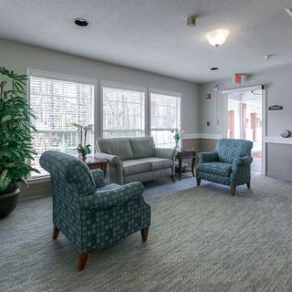 A cozy living room with comfortable seating and large windows.