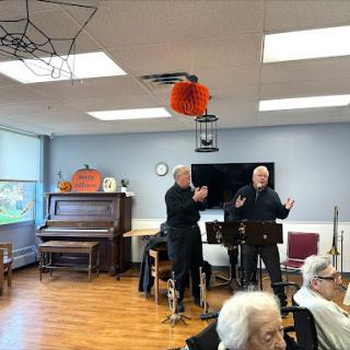 Musicians entertaining seniors at a community center.