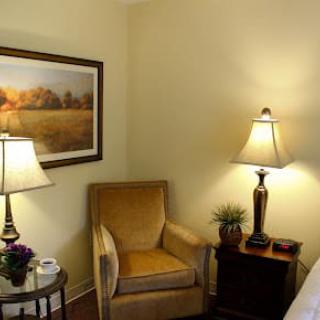 Cozy living room corner with a comfortable chair and warm lighting.