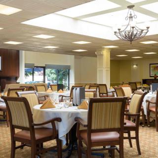 Elegant dining area with neatly set tables and comfortable seating.