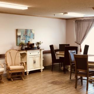 A cozy and well-furnished dining area with a combination of chairs, a table, and decorative elements.