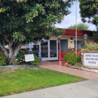 Entrance to a health and wellness center with surrounding greenery.