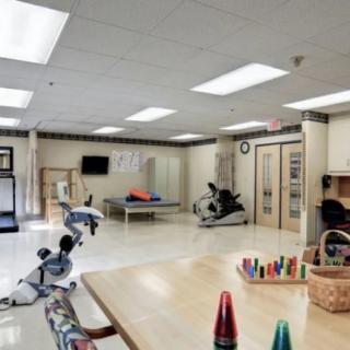 A well-equipped rehabilitation center with exercise equipment and therapy areas.