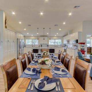 A beautifully set dining table in a modern, open-concept kitchen and dining area.