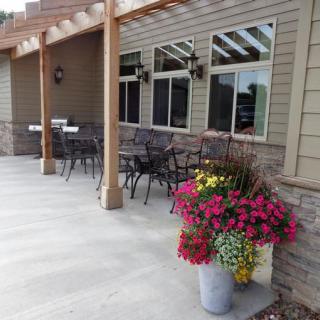 A patio with outdoor seating and a colorful flower planter.