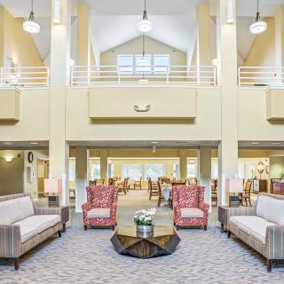 Spacious and well-lit lobby with elegant furniture arrangement.