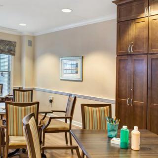 A cozy dining room with wooden furniture and decorative elements.