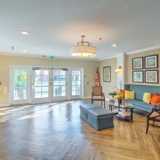 A spacious and elegantly designed living room with wooden flooring, comfortable seating, and tasteful decor.
