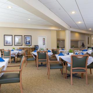An elegantly set dining area with tables and chairs arranged for guests.