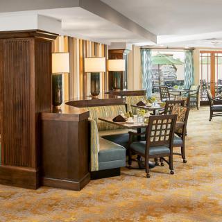 A cozy restaurant dining area with wooden furniture and soft lighting.