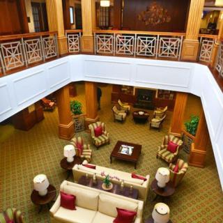 A luxurious hotel lobby featuring elegant furniture and intricate architectural details.
