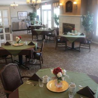 Elegant dining room with neatly set tables and floral centerpieces.