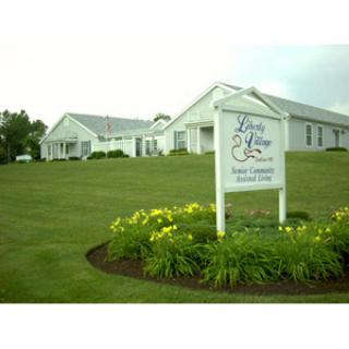 A welcoming entrance to a community facility, surrounded by well-maintained grass and flowers.