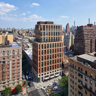 A view of a cityscape with modern and traditional buildings under a clear blue sky.