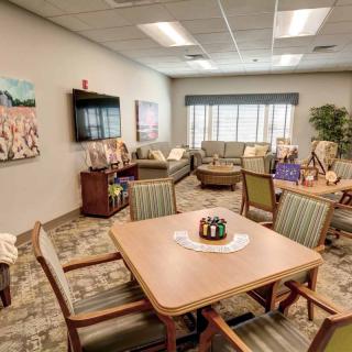 A cozy waiting room with comfortable seating and decorative art.