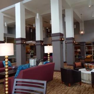 A modern lobby with comfortable seating and elegant lighting fixtures.