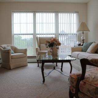 A cozy living room with comfortable seating and large windows.