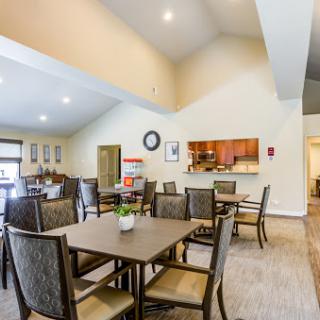 A spacious and inviting dining area with modern furniture, perfect for community gatherings.