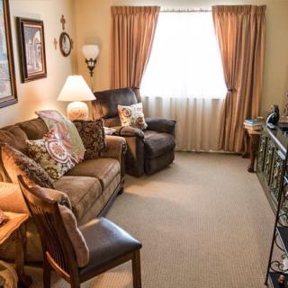 A cozy living room with comfortable seating and warm lighting.