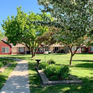 A serene neighborhood with a landscaped garden and walkway on a sunny day.