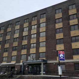 Facade of a hotel building featuring multiple windows and a prominent entrance.