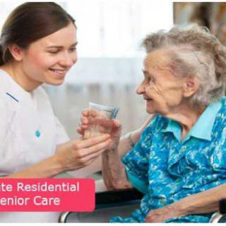 A caregiver providing residential senior care to an elderly woman.