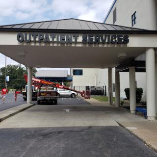 Entrance to a service facility with a parked vehicle.