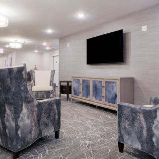 A modern living room with stylish furniture and a wall-mounted television.