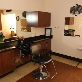 A cozy hair salon setup with a styling chair and mirrors.