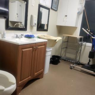 A view of a functional bathroom space with essential fixtures and medical equipment.